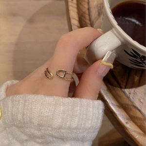 Detailed view of an adjustable gold-plated double-layer ring with hollow H-shaped design
