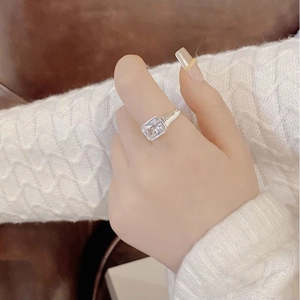 Detail of square zircon silver ring on hand with modern bezel setting for women