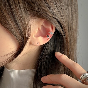 Close-up of minimalist S925 silver ear cuffs with zircon and black stone on ear