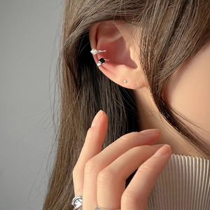 Close-up of S925 silver ear cuffs with zircon stones on a model's ear