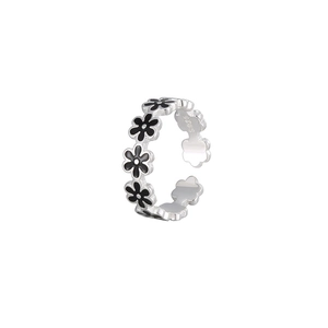 Adjustable S925 sterling silver ring featuring five black enamel flower motifs on a white base
