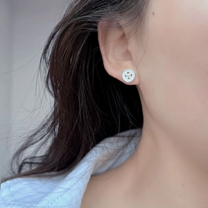 Vintage 925 sterling silver button stud earrings with clover engraving on female model