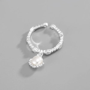 Macro detail of wave texture S925 silver ring with shell charm and natural pearl
