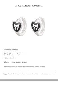 Macro detail of S925 sterling silver black heart earrings with white bow pattern