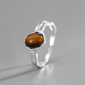 Macro view of textured S925 sterling silver ring featuring a brown tiger eye stone