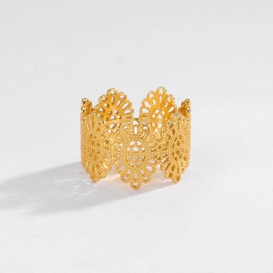 Detailed view of vintage lace hollow design gold silver ring with floral patterns