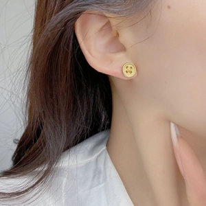 Vintage 925 sterling silver button earrings with gold finish on female model