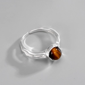 Detailed view of S925 sterling silver S925 stamp and textured band with brown tiger eye stone