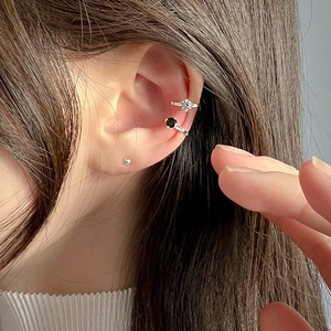 Close-up of S925 silver ear cuffs with white and black zircon on a model's ear