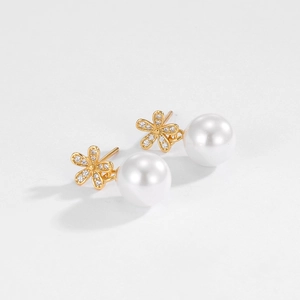 Close-up of S925 sterling silver flower earrings with pearl drop and zircon crystals