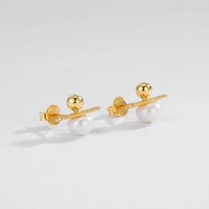 Detail showing S925 hallmark on minimalist gold-plated silver pearl stud earrings
