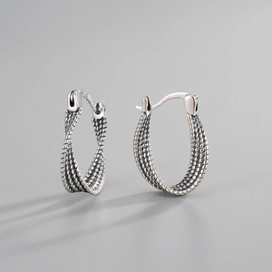Macro view of S925 sterling silver twisted hoop earrings with vintage braided texture