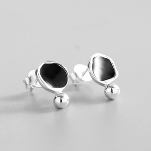 Macro detail of S925 sterling silver geometric earrings with black enamel inlay and round bead