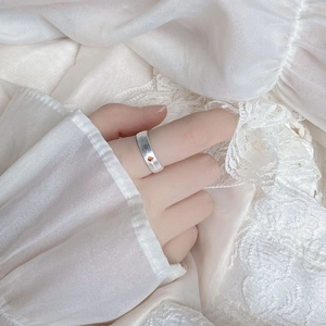 Detailed view of S925 silver star ring featuring a small orange gemstone on a female finger