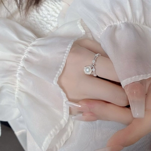 Macro detail of S925 sterling silver shell ring with natural pearl and pavé cubic zirconia