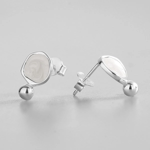 Macro view of S925 silver irregular enamel earrings with bead pendant detail