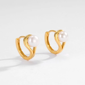 Detailed close-up of 925 silver gold-plated hoop earrings with natural freshwater pearls