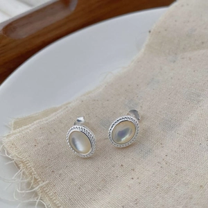 Boucles d'oreilles ovales en argent S925 avec nacre blanche et bordure torsadée chic