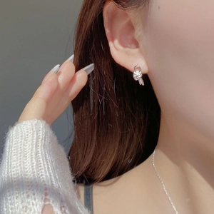 Minimalist S925 sterling silver double knot stud earring worn for a lifestyle look