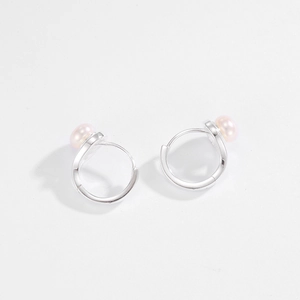 Close-up of 925 silver hoop earrings featuring natural pink freshwater pearls on white back