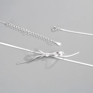 Macro shot of S925 sterling silver blade chain with flat bow centerpiece detail