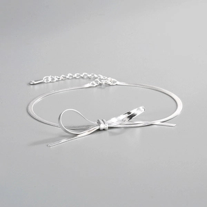 Detail of S925 sterling silver bow bracelet featuring a sleek herringbone flat snake chain