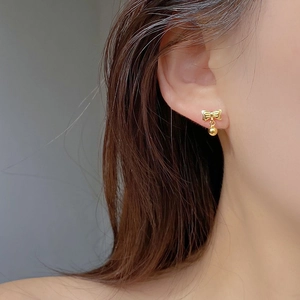 Elegant S925 silver bow stud earrings with small gold bead pendant on female ear