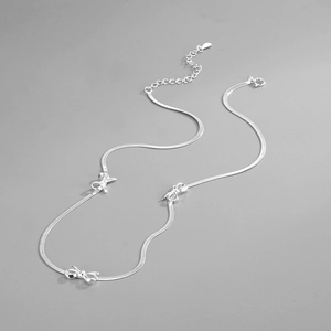 Detailed shot of S925 silver bow necklace with snake chain and adjustable lobster clasp