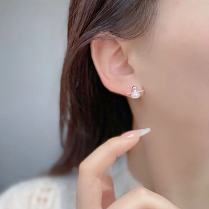 Close-up of minimalist S925 sterling silver bar earring with natural freshwater pearl on ear