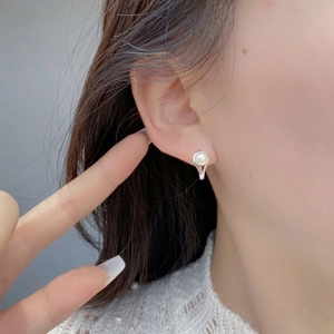 Elegant 925 sterling silver hoop earrings with natural freshwater pearl on model
