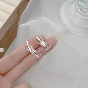 Minimalist 925 sterling silver bow knot stud earrings held for size display