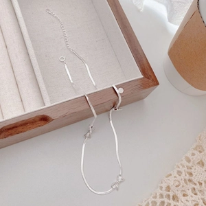Elegant S925 sterling silver bow snake chain necklace on a classic jewelry box