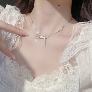Elegant S925 sterling silver bow pendant necklace with snake chain on model neck
