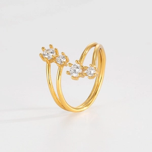 Detail of double-layer gold star ring with four sparkling white zircons in prong setting