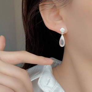 Macro detail of matte S925 sterling silver drop earrings with natural agate stones