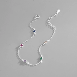 Macro shot of S925 sterling silver bracelet featuring five colorful bezel-set round gems