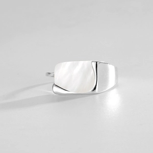 Macro shot of rectangular white shell inlay on a minimalist silver adjustable ring