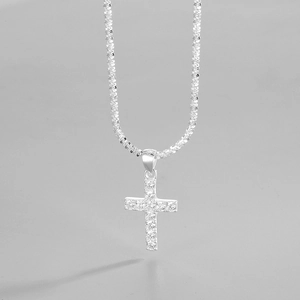 Macro view of sterling silver cross pendant featuring sparkling pave-set cubic zirconia
