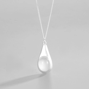 Macro detail of S925 sterling silver water drop pendant with translucent gemstone inlay