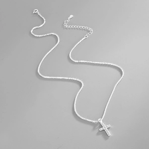 Close-up of sparkling S925 sterling silver cross necklace with pavé cubic zirconia stones