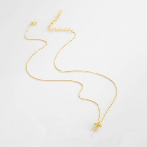 Detail of gold cross necklace featuring box chain and adjustable lobster clasp closure