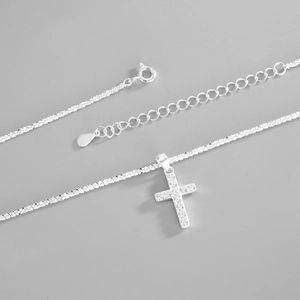 Detail of S925 sterling silver cross necklace with sparkling pave diamonds and lobster clasp