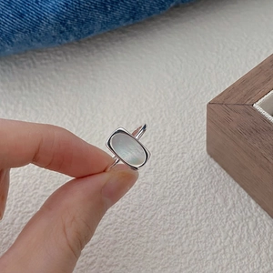 Detail shot of a S925 silver ring featuring a rectangular white shell mother of pearl inlay