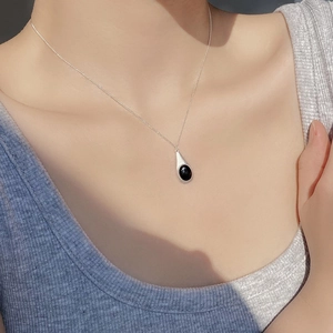 Minimalist S925 silver necklace with teardrop black onyx pendant worn by a model