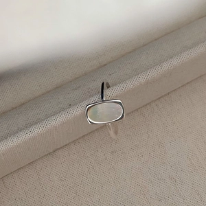 Detailed view of S925 silver ring featuring a rectangular white shell inlay on cotton