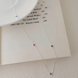 Detail of S925 sterling silver necklace with five round multi-colored crystal charms