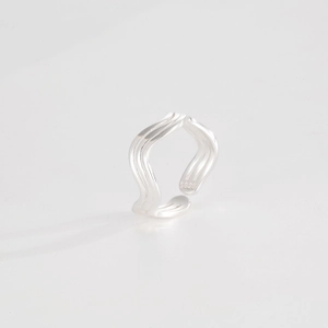 Macro shot of silver S925 hallmark on the inner band of the wave-designed ring
