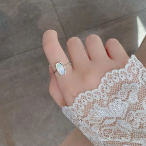 Elegant S925 sterling silver ring with rectangular white shell inlay on model's hand
