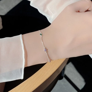 Close-up of S925 silver bracelet with colorful round zircon stones on a woman's wrist
