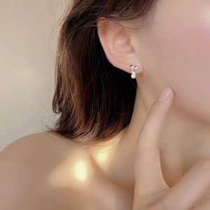 French vintage S925 silver cross knot earrings with pearls on model in natural light